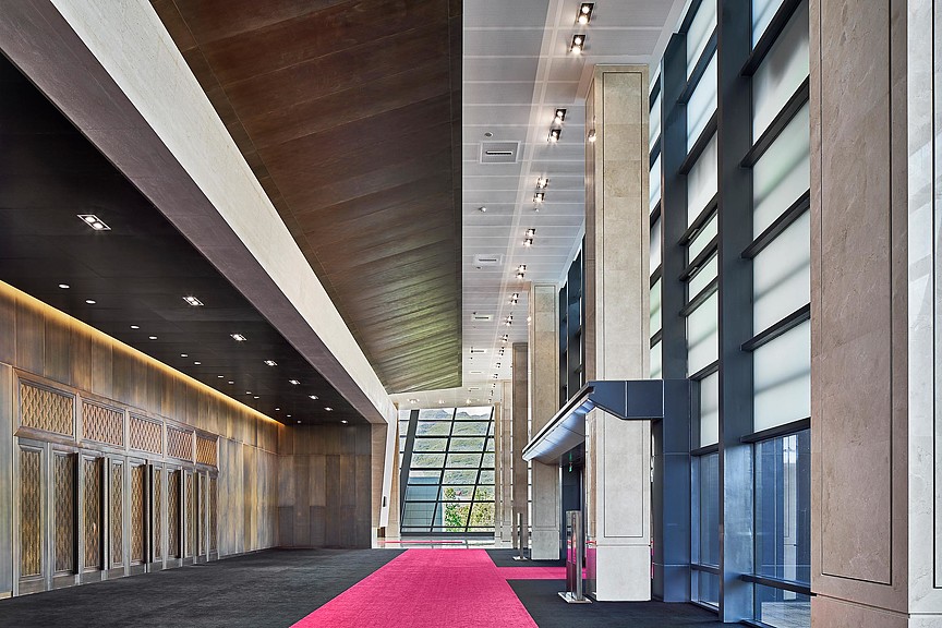 A room with a red carpet and a red carpet.